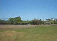 青空の下の緑の芝が広がった二宮運動場の写真